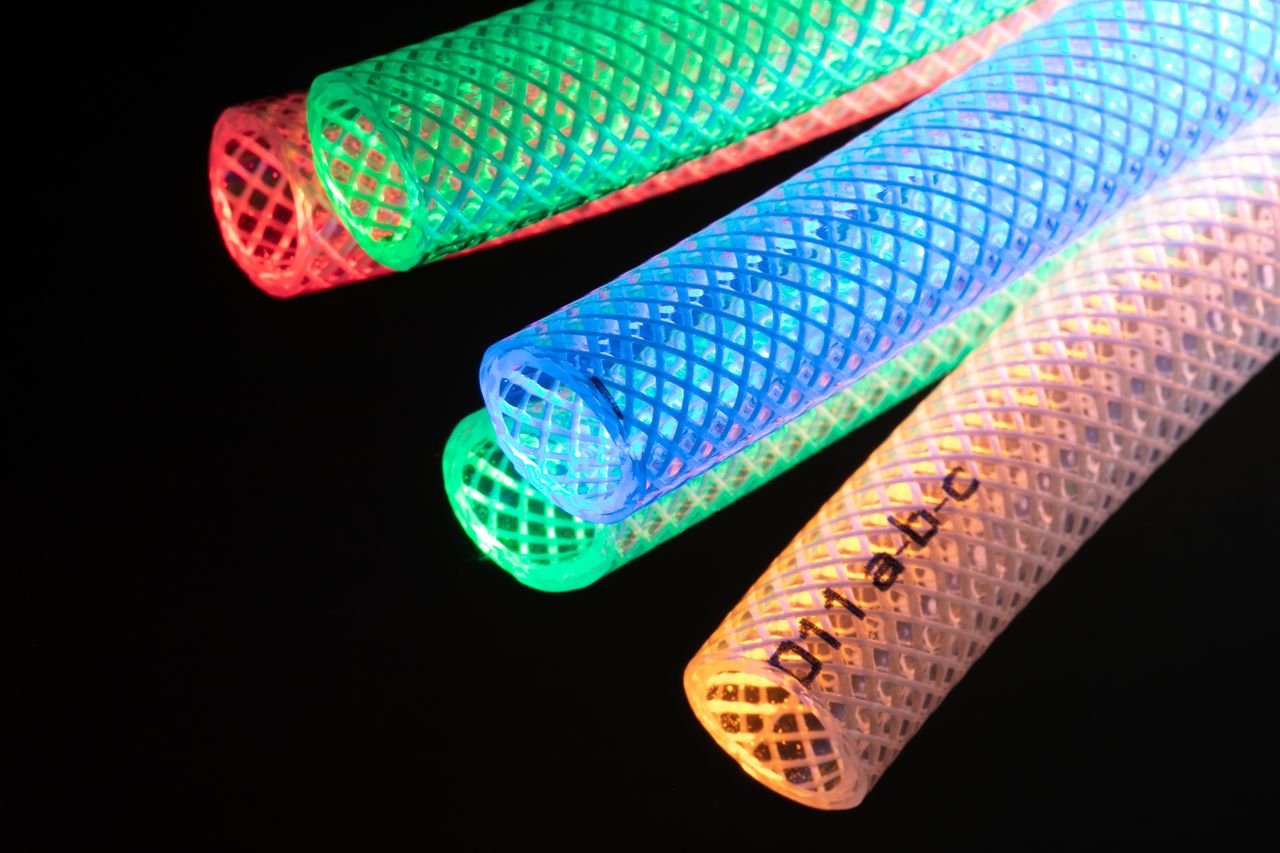 Services Vibrant illuminated mesh tubes in red, green, blue, and yellow against a dark background.