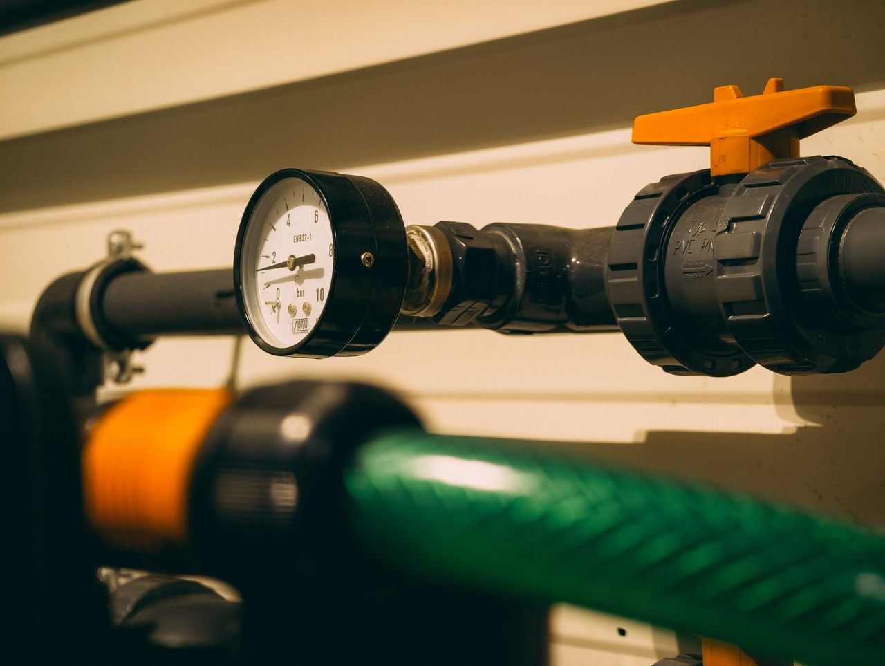 Services Close-up view of an industrial pressure gauge attached to piping. Ideal for engineering or industry visuals.